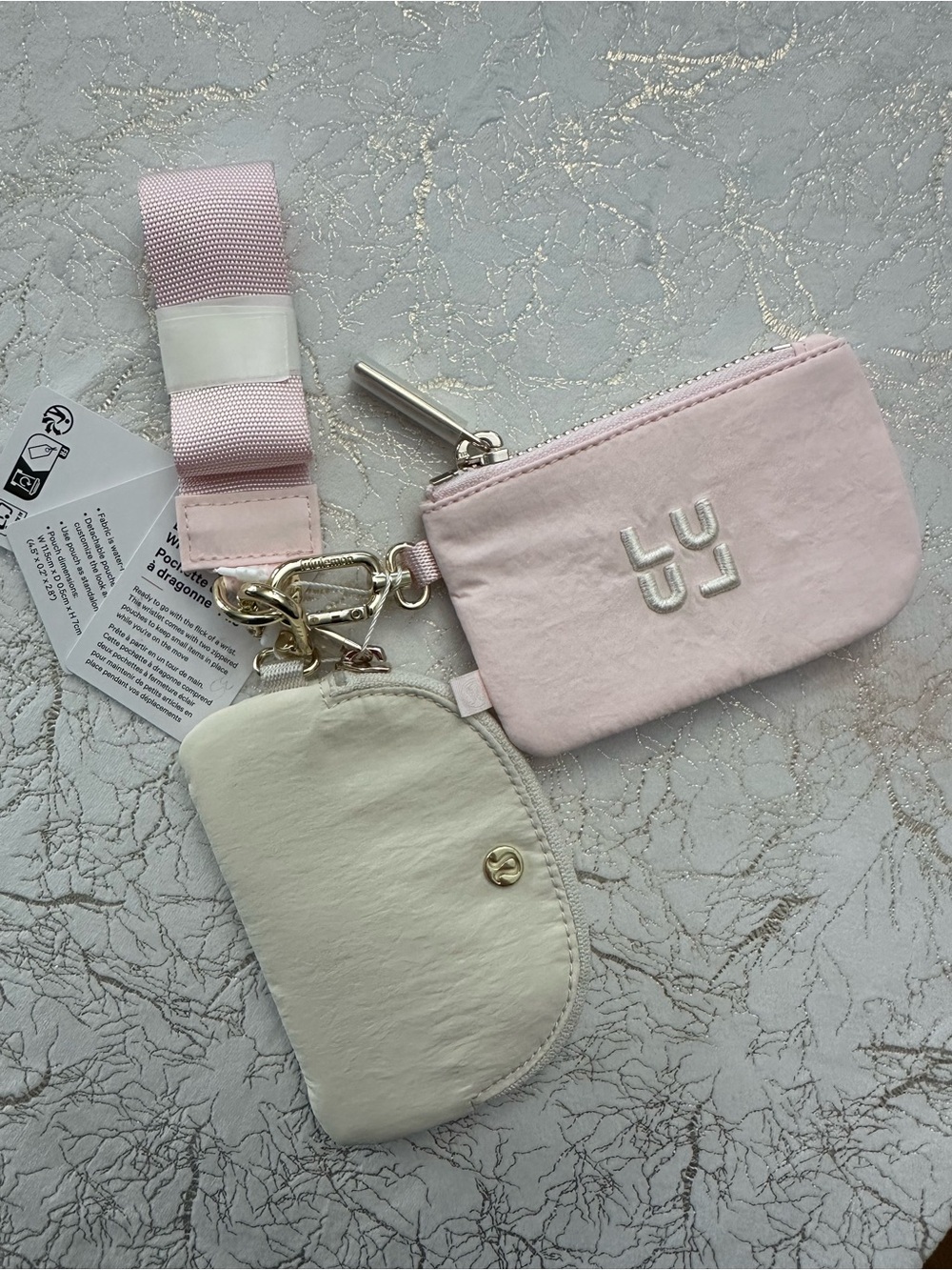 Lululemon dual pouch wristlet in pink and cream.